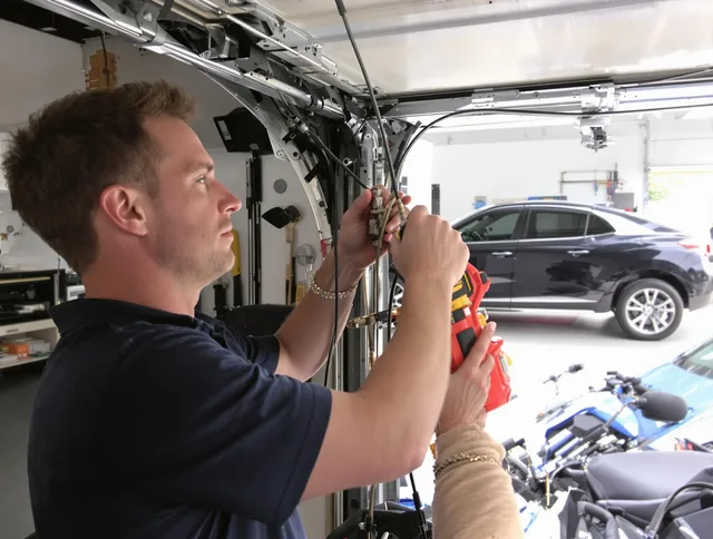 Bay Village Garage Door Repair safety certified technician performing cable replacement in Bay Village